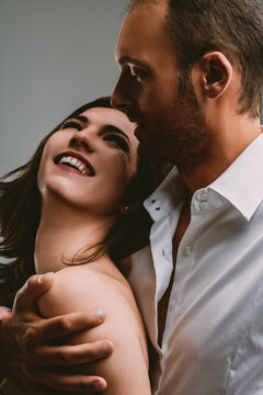 Smiling woman feels secure, man's calm embrace