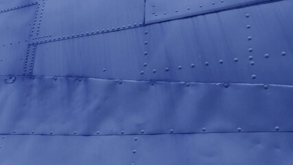 Side of the fuselage of an old airplane.