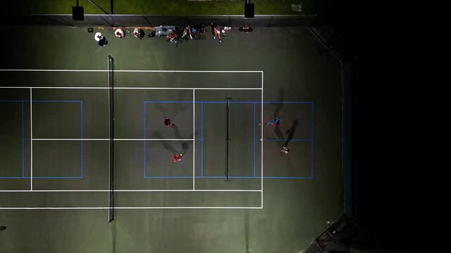 Pickleball night time drone shot one court long dink rally