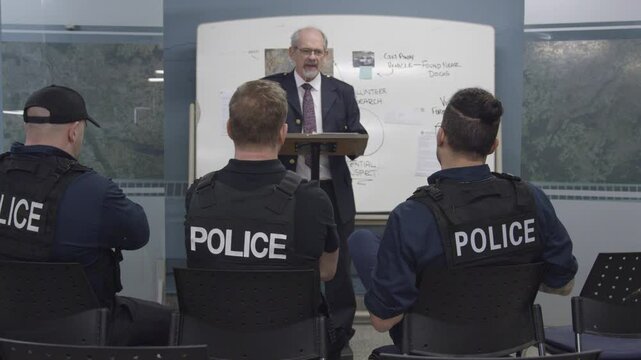 Police chief briefing officers zoom out