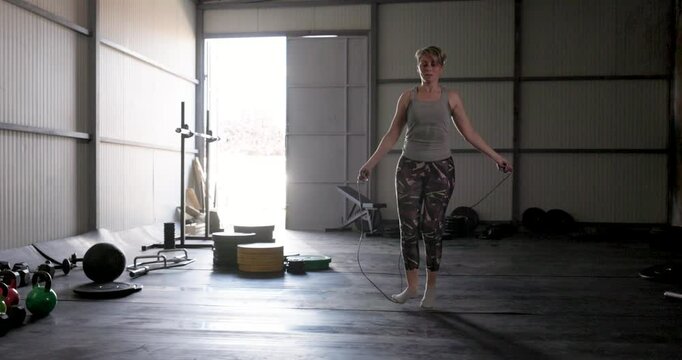 Mature Woman Jumping Rope as a Warm Up At The Gym