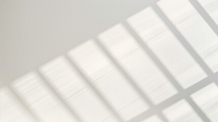 Abstract light shadows cast through windows creating a geometric pattern on a white background.