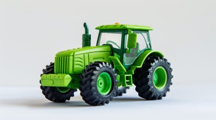 Green toy tractor on a white background. Plastic child toy. Construction vehicle. Toy tractor. 