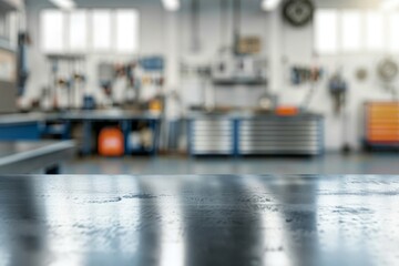 Obraz premium A metal blank tabletop with blurred automotive tools and parts in the background suitable for promoting automotive products