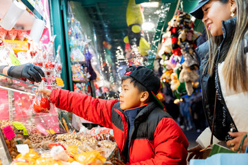 Asian family enjoying a festive evening at a Christmas market