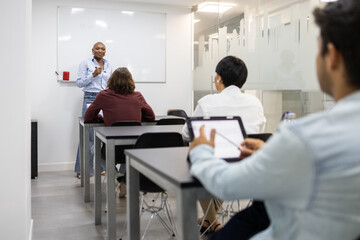 African American educator leads a diverse adult English class