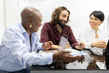 Diverse team discussing project in modern office setting