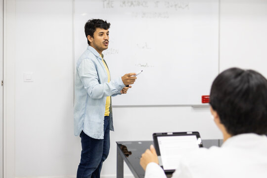 Teacher presenting a lesson in a modern classroom setting