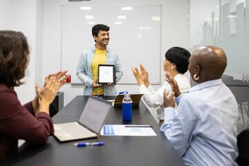 Young man receives recognition from a team in an English class