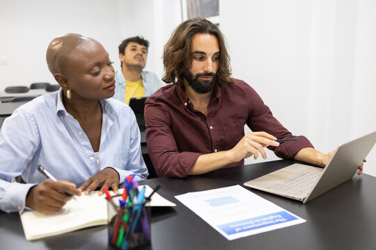 Diverse colleagues collaborate at an English academy meeting