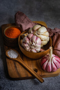Rustic garlic and spices culinary setup on wooden table