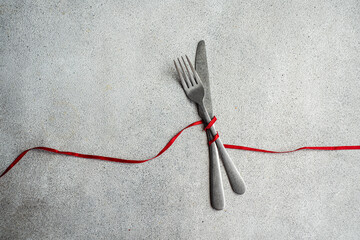 Minimalist table with a red ribbon on concrete background
