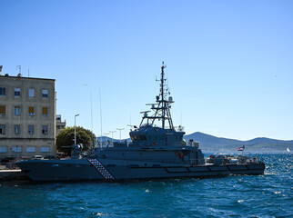 Croatian coast guard ship sailing near the coast on a sunny day