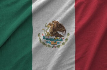 Mexico flag depicted on folded wavy fabric of old cloth close up