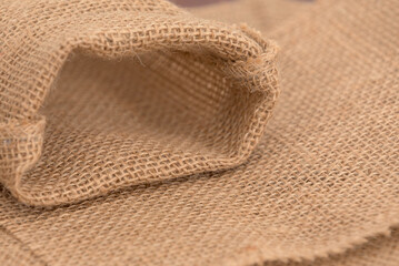 A piece of burlap fabric with a hole in it