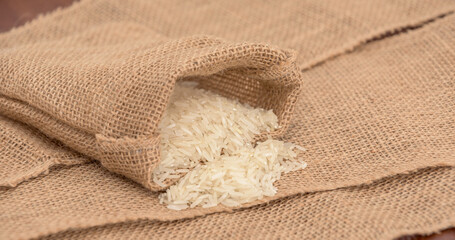 A bag of rice is sitting on a brown cloth