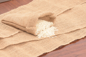 A bag of rice is sitting on a table with a piece of cloth