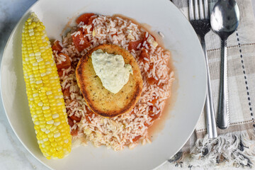 salmon burger on rice with tomatoes