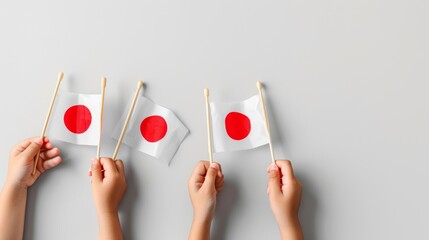 Close-up of hands with mini Japan flags, highlighting themes of unity, national pride, and minimalism