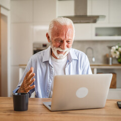 Fototapeta premium Senior caucasian man have a video call on laptop at home