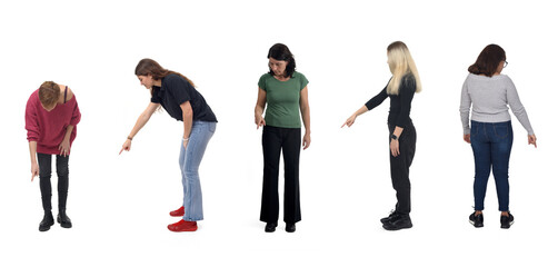 Obraz premium group of woman pointing finger at the ground on white background