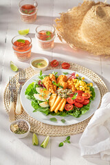 Delicious and fresh salad served with mustard sauce and lemonade.