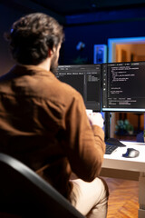 Computer engineer doing software quality assurance, reading source code on screen before implementing it. IT admin inspecting coding on desktop PC, looking to fix potential issues