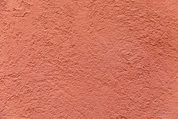 pattern of red painted plaster wall with rough structure