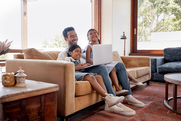 Laptop, laughing and movie with family on sofa in living room of home together for bonding or...