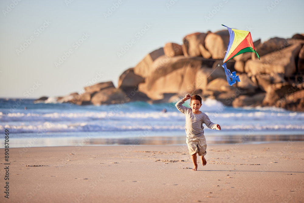 Poster Boy child, kite and running on beach for vacation and holiday with smile, fun and outdoor summer for travel. Growth, flying and fast male kid by sea for adventure with wellness and playing by ocean