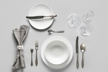 Beautiful table setting with silver cutlery on white background