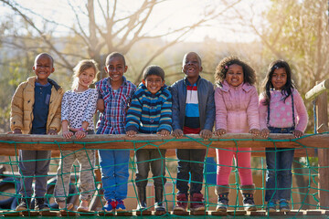 The park is our happy place. Portrait of a group of little children standing together outside.