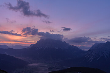 Zugspitze peak against clear dusk sky at sunset in Garmisch-Partenkirchen town in Bavaria, Germany