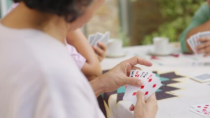 Group of Happy Asian senior mature women relax and enjoy indoor lifestyle meeting party together at home. Elderly retired woman friends having fun playing card together at home garden in summer day. - Powered by Adobe
