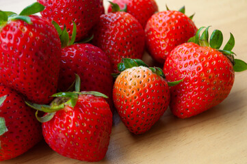 Close up of strawberries on wooden table background. Healthy food and fruits concept