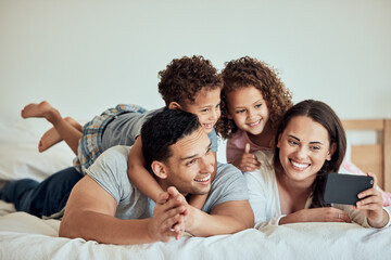 Family, excited and happy on bed for selfie, relationship development and weekend fun at home....