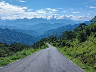 Naklejka premium Serene Mountain Road: Tranquil Nature's Beauty under Deep Blue Sky