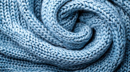 An exquisitely detailed image of light blue knitting, featuring swirls and curves that demonstrate the intricate artistry involved in creating such beautifully crafted textiles.