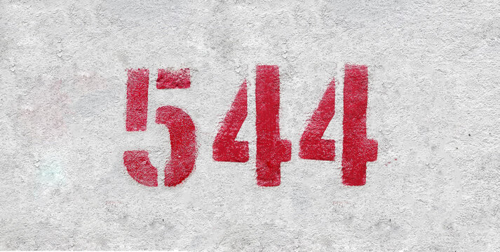 Red Number 544 on the white wall. Spray paint.