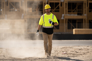 A construction worker in highvisibility gear emphasizes safety and professionalism at a dusty work site