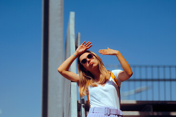 Woman Suffering from Heat During City Walk in Sunny Day. Person trying to cool off making desperate...