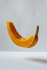 Honey Boat Delicata Pumpkin levitating on a white background