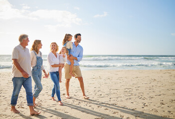 Travel, happy and big family walking on beach on summer vacation, journey and getaway for bonding on spring break. Grandparents, parents and children by ocean water with love, adventure and wellness.