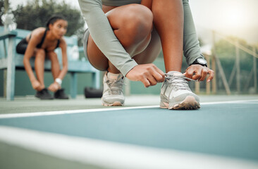 Workout, women and hands tie shoes before training for cardio, match or fitness preparation. Floor, sports and feet of athlete friends for prepare, fasten sneakers or ready to start on tennis court