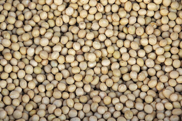 Close up and top angle view of stacked dried soybean with yellow seeds for sale in a traditional market, South Korea
