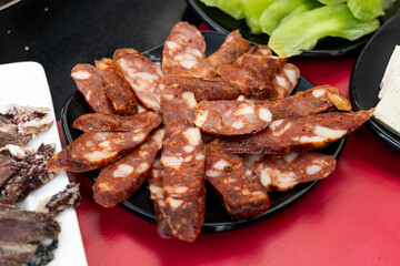 Serving of cured or preserved meat with mala as one of the ingredients in Tibetan hotpot or steamboat in Sichuan, China