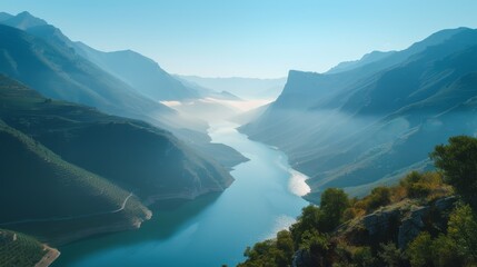 Obraz premium Scenic River Flowing Through Mountain Valley