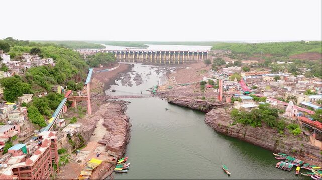 Aerial view of river dam and bridge in rocky terrain