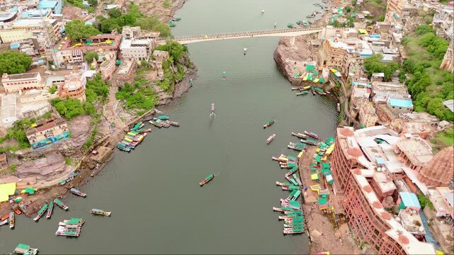 Narmada river india flowing through a large village