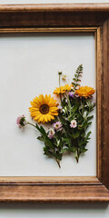A wooden picture frame adorned with fresh flowers.